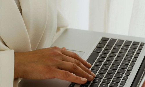 a person typing on a laptop